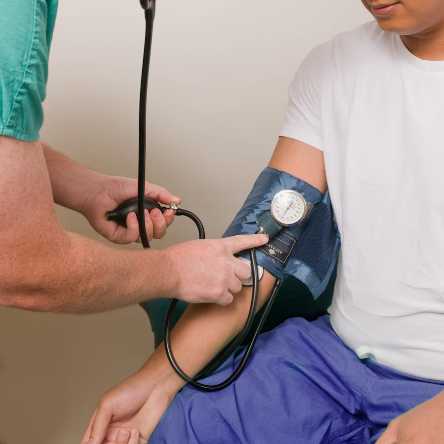 Doctor checking a patient's vitals during a visit